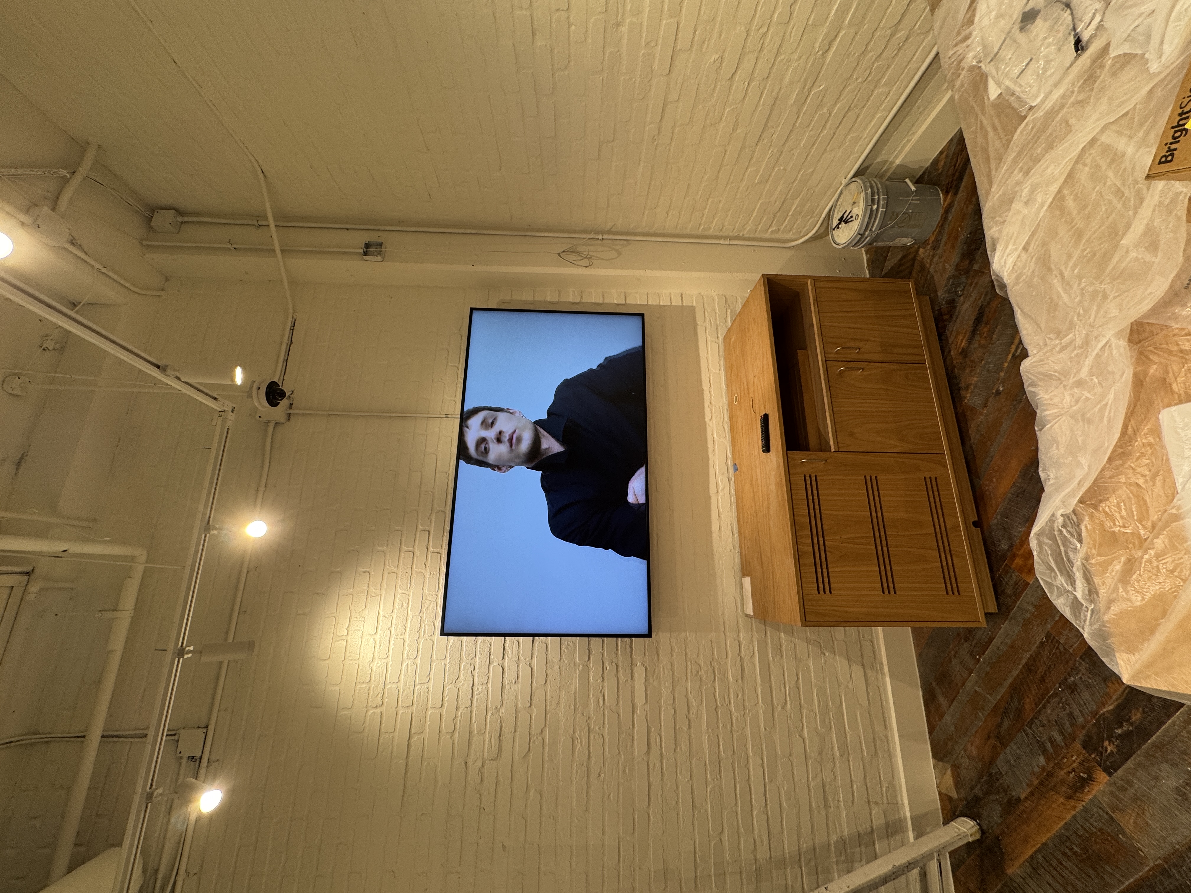 Retail digital signage installation with wall-mounted display and clean cable management